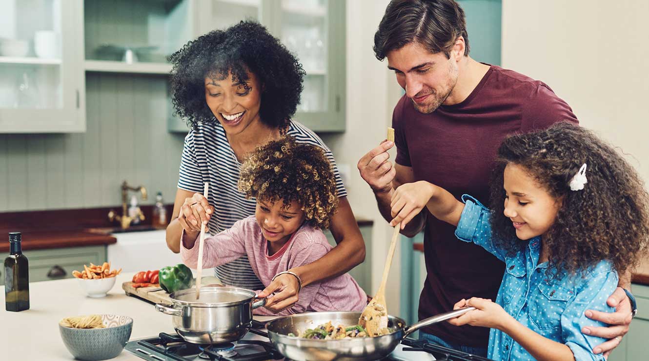 Picture of family making dinner together.