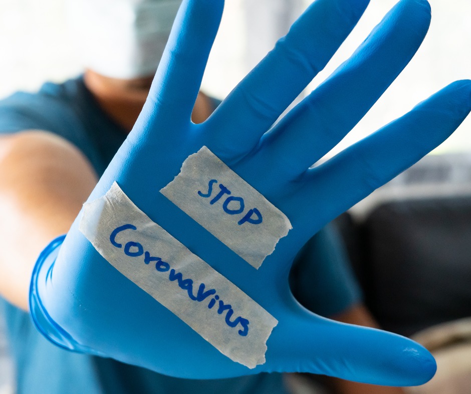 Image of blue glove with "Stop Coronavirus" written on it.
