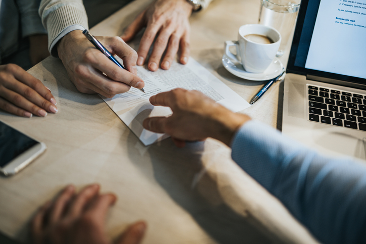 Image of hands working on a document.