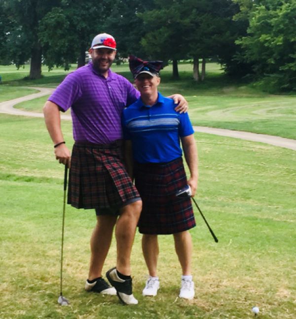 Picture of two people posing at a golf course.